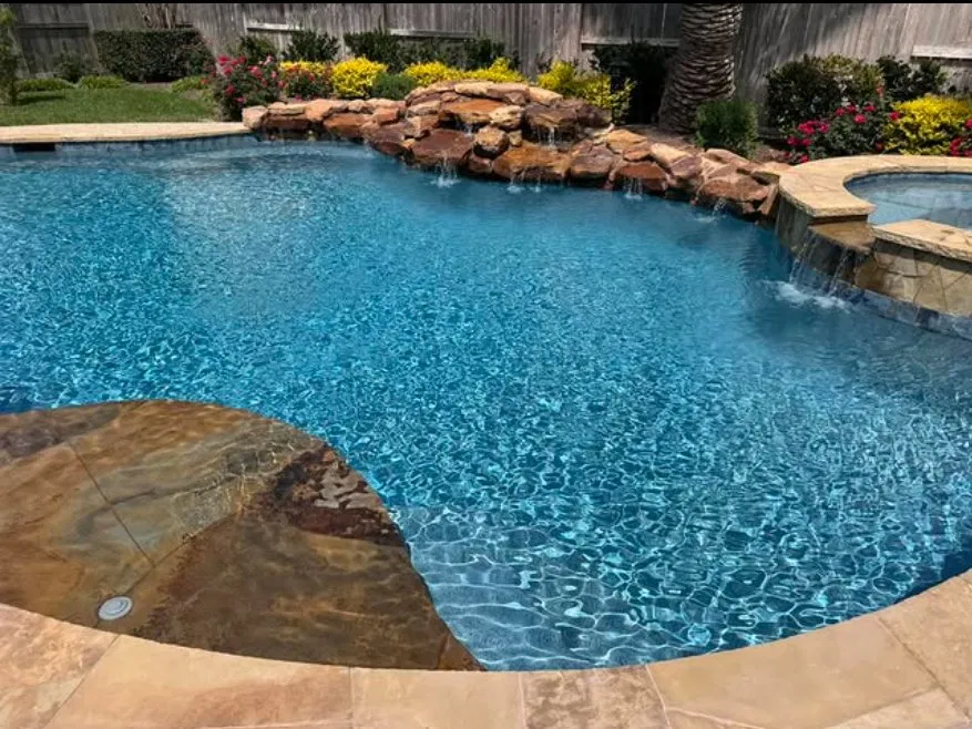 Freeform pool with rock waterfall feature