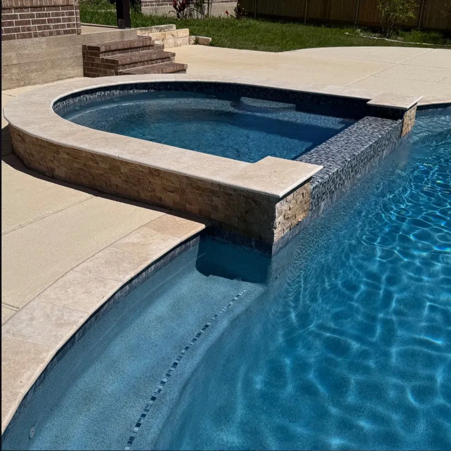 Spa with travertine coping and mosaic tile